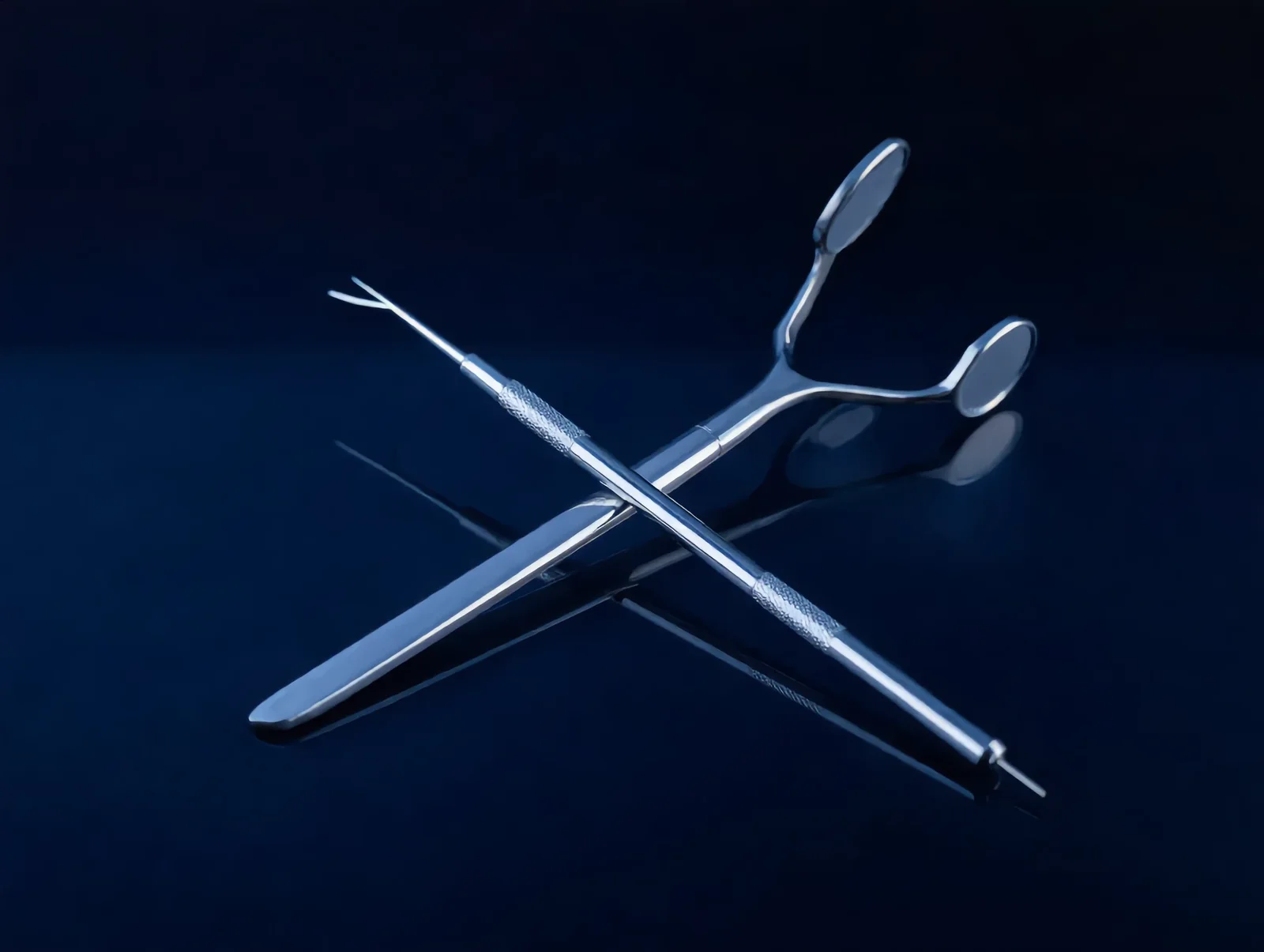 Clinical render of a dental mirror and explorer on a dark blue surface
